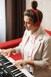 Side view of woman playing piano