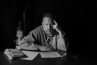 Portrait of a man sitting on table