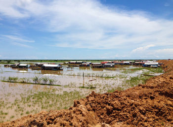 Boats moored at beach against sky