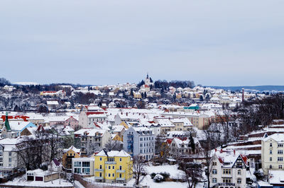 Snow covered meissen townscape against sky during winter