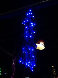 Low angle view of illuminated christmas tree at night