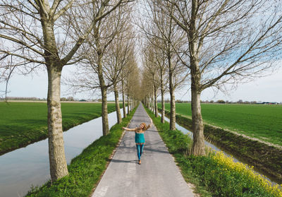 Woman walking on footpath in park