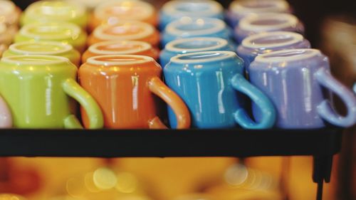 Close-up of colorful cups arranged on table