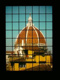 Close-up of building against sky seen through window