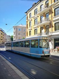 Cars on road in city against sky