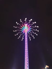 Low angle view of illuminated ferris wheel against sky at night