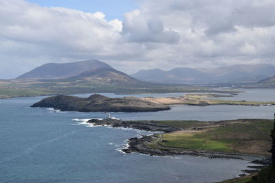 Scenic view of sea and mountains against sky