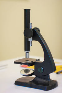 Close-up of camera on table against wall