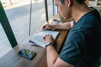 Side view of man using mobile phone