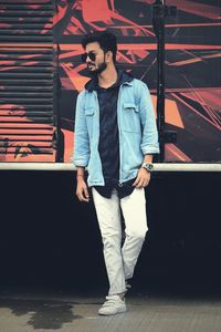 Full length portrait of young man looking at camera