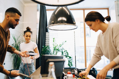 Young multi-ethnic programmers working at small creative office