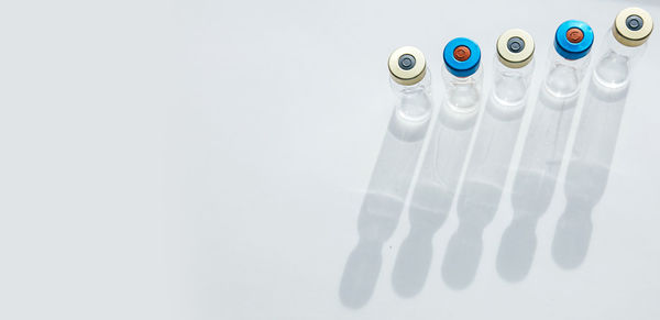 High angle view of drinking glasses on white background