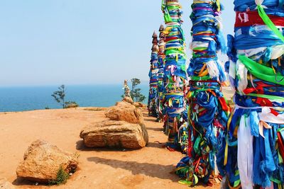 Multi colored rocks on beach against clear sky