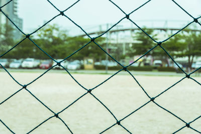 Rope net with blurred sand soccer field