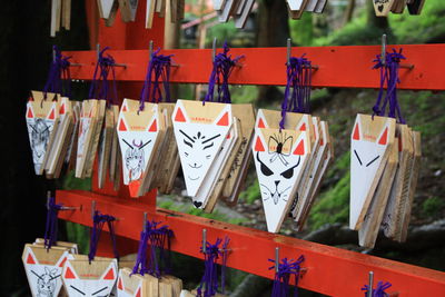 Close-up of multi colored flags hanging in row