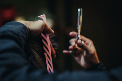 Hairdresser cutting customer hair in salon