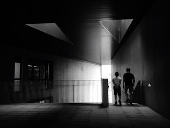 Rear view of people standing in corridor