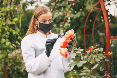 Woman holding flowering plants