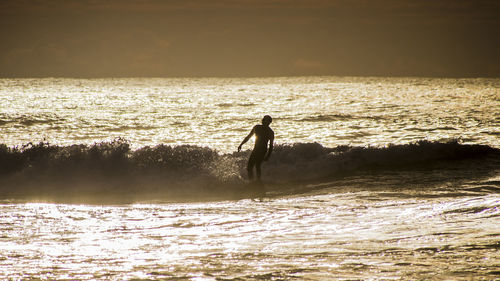 Silhouette of woman in sea