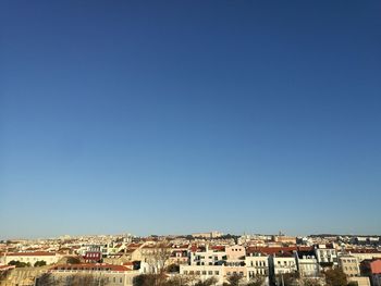 Cityscape against clear blue sky