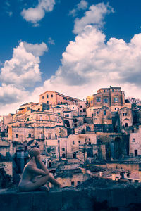 Cityscape against cloudy sky