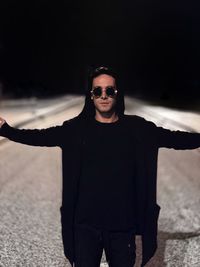 Portrait of young man wearing sunglasses standing outdoors