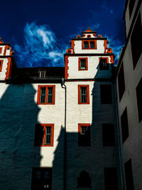 Low angle view of buildings against sky at night