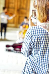 Rear view of woman standing on street