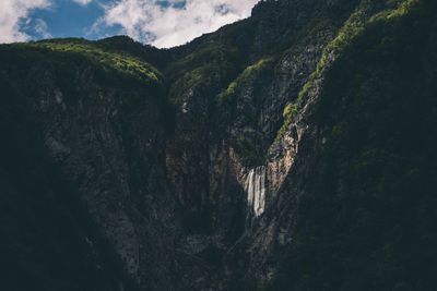 Low angle view of rocky mountains against sky