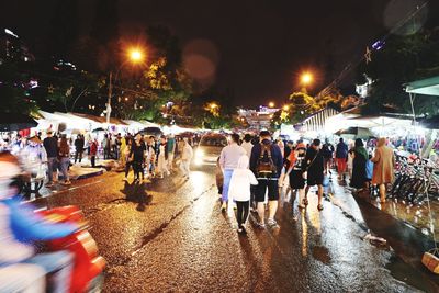 People on illuminated city at night
