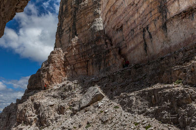 Low angle view of rocky mountains against sky