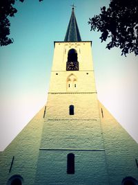 Low angle view of bell tower against sky