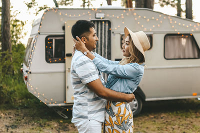 Married asian couple in love travel by camper car on a road trip in nature on their honeymoon