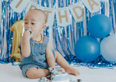 Cute boy playing with toys on table