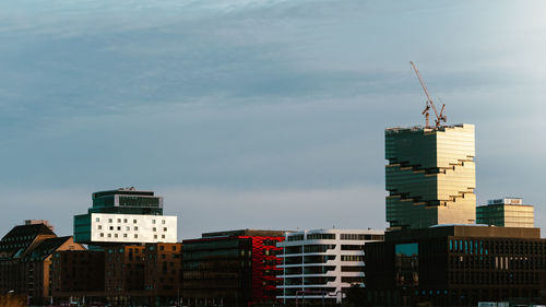 Modern buildings in city against sky