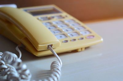 Close-up of telephone on table