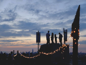 Silhouette of city against sky during sunset