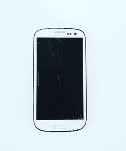 Directly above view of smart phone against white background