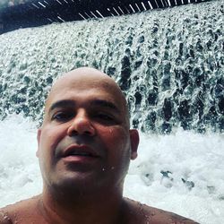 Portrait of shirtless man in swimming pool