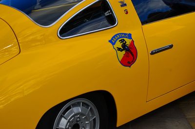 Close-up of yellow car parked