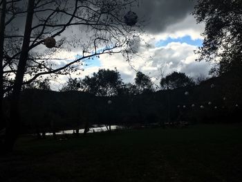 Scenic view of grassy field against cloudy sky