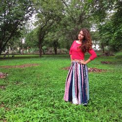 Portrait of young woman standing on grass