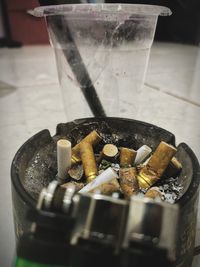 Close-up of cigarette smoking on table