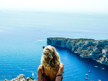 Rear view of woman looking at swimming pool