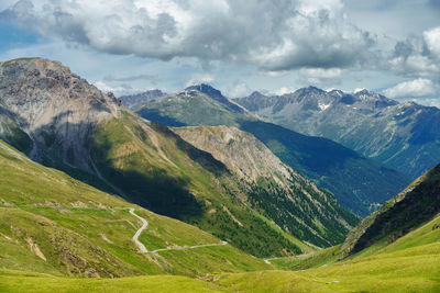 Scenic view of valley and mountains against sky