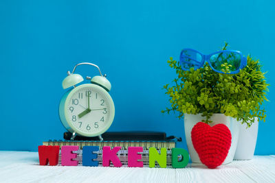 Close-up of potted plant on table against wall