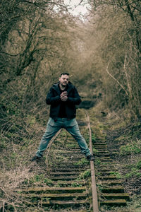 Portrait of a serious young man in forest