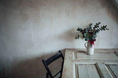 High angle view of vase with bunch of flowers on table