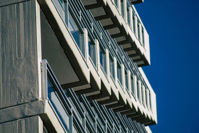 Low angle view of modern building against clear blue sky