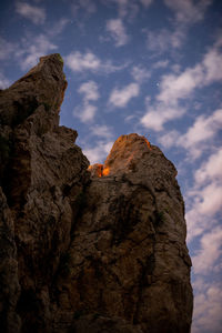 Low angle view of rock formation against sky